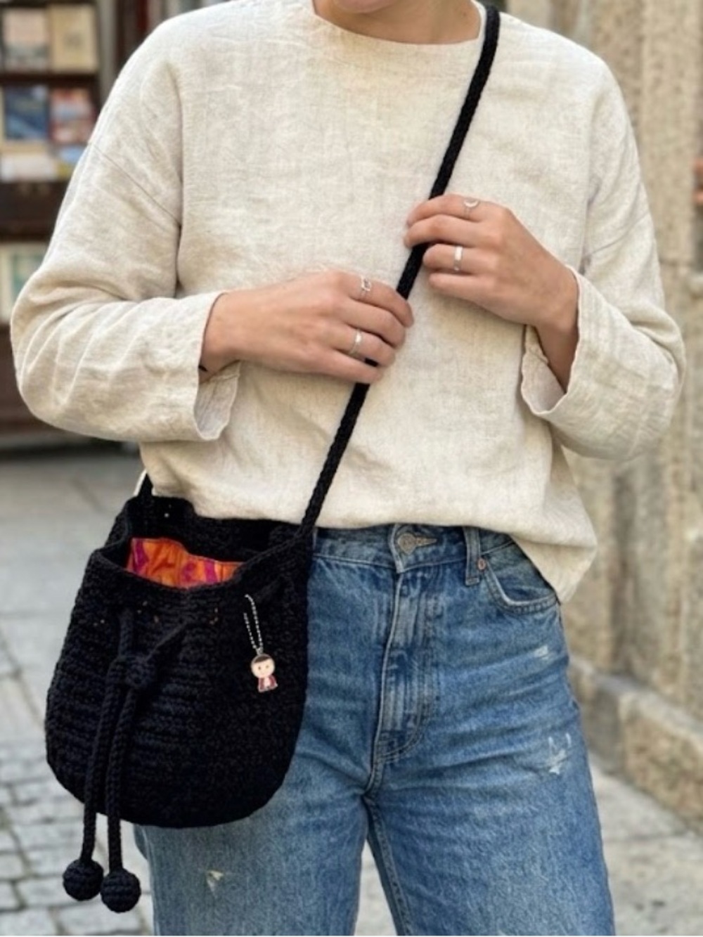 The Sak Black Crocheted Crossbody Bag with Colorful Lining